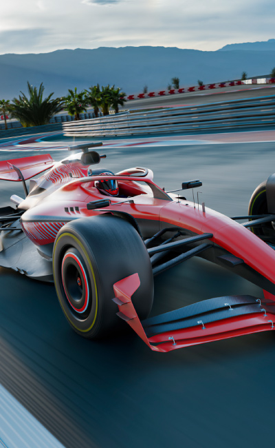 Dos autos de Fórmula 1 avanzan a gran velocidad sobre el circuito, con el cielo despejado al fondo, está es una escena típica de quienes asisten con entradas para el circuito de Barcelona a disfrutar la emoción de la carrera